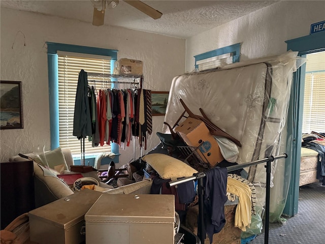 724 Ave D SW, Winter Haven, FL 33880 - carpeted bedroom with a textured wall, a textured ceiling, multiple windows, and ceiling fan