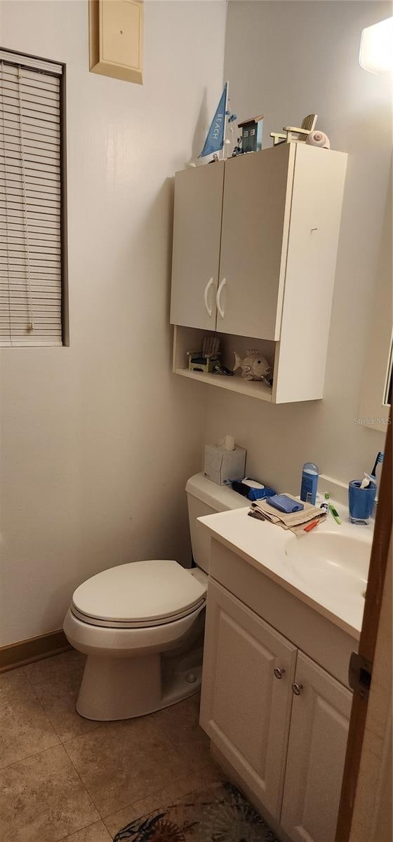 bathroom with vanity, toilet, and tile patterned flooring