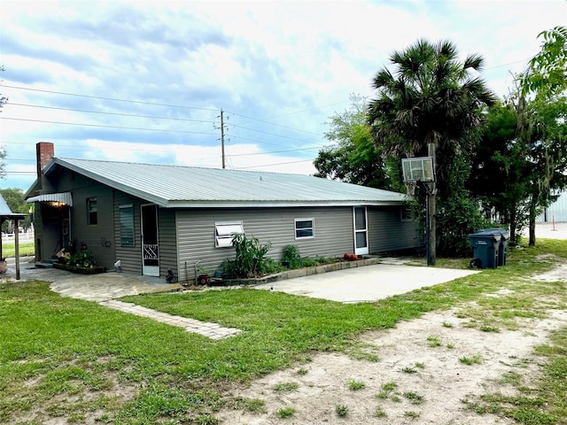 rear view of property featuring a yard