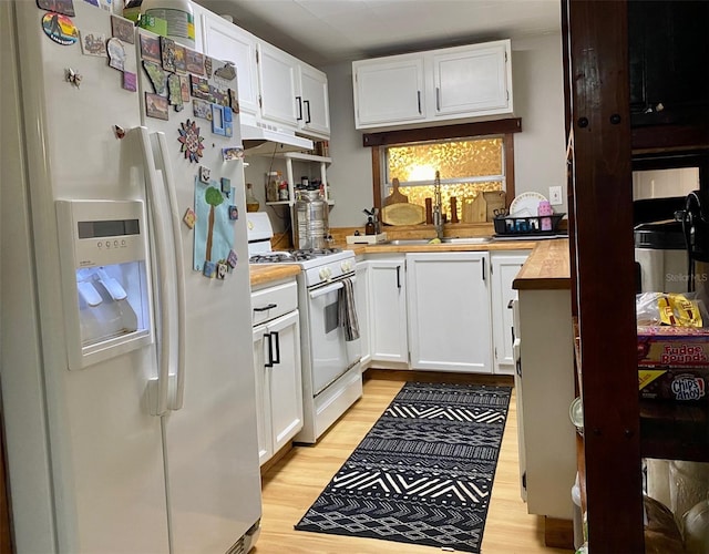 kitchen featuring light hardwood / wood-style floors, white appliances, white cabinets, and sink