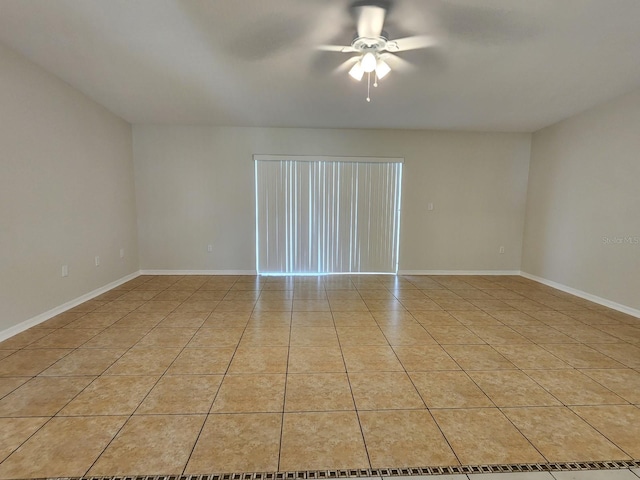 tiled spare room featuring ceiling fan