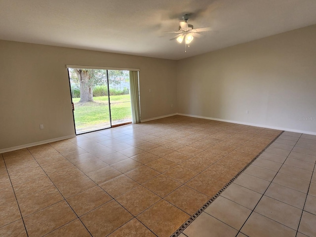 tiled empty room featuring ceiling fan