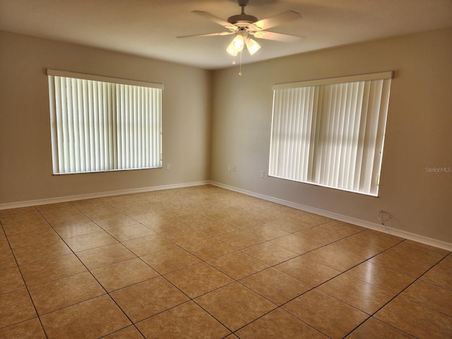 tiled empty room with ceiling fan