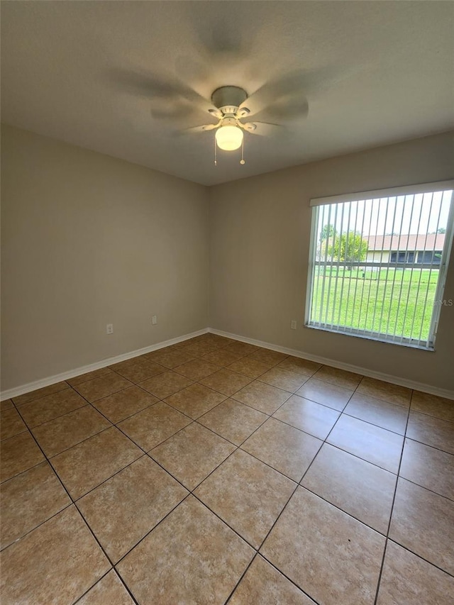 spare room with light tile flooring and ceiling fan