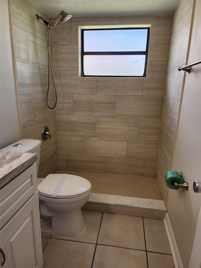 bathroom featuring plenty of natural light, toilet, vanity, and tile flooring