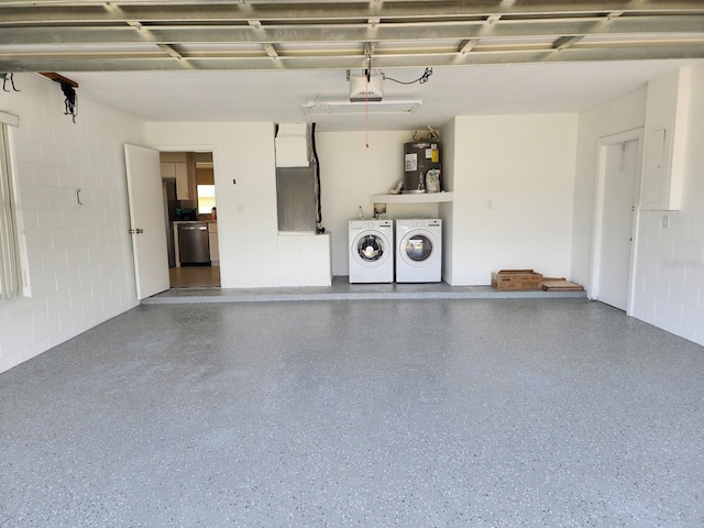 garage with electric water heater and independent washer and dryer