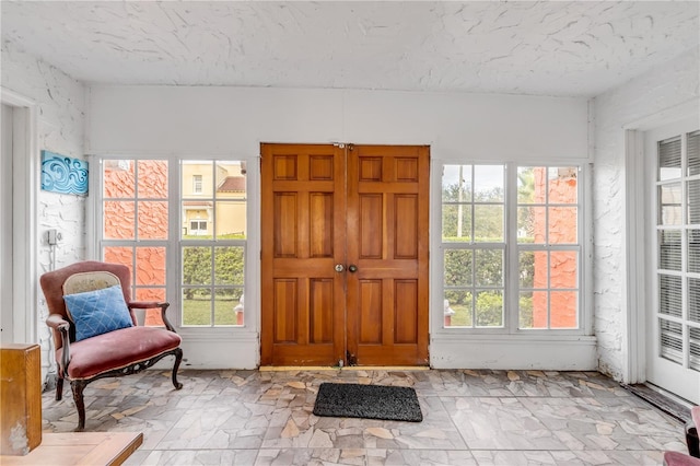 foyer featuring a healthy amount of sunlight and light tile flooring