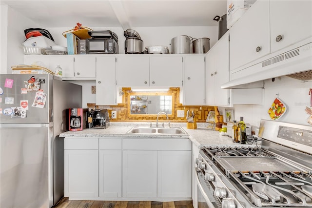 kitchen with light hardwood / wood-style flooring, white cabinetry, appliances with stainless steel finishes, backsplash, and sink