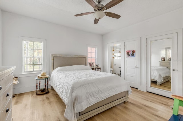 bedroom with light hardwood / wood-style floors and ceiling fan