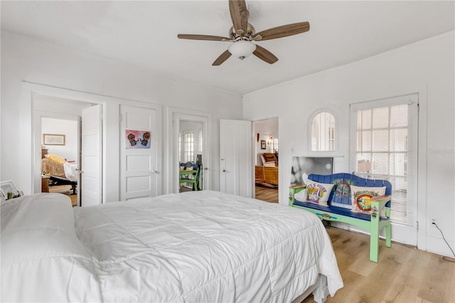 bedroom with light hardwood / wood-style flooring and ceiling fan