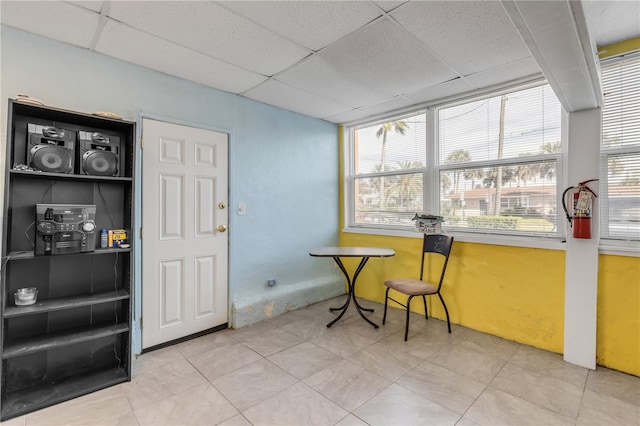 tiled home office with a drop ceiling