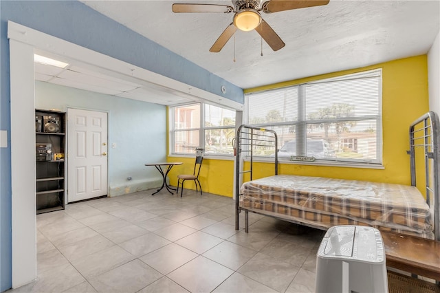 bedroom featuring light tile floors and ceiling fan