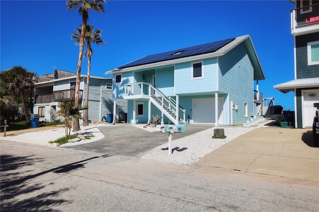 view of front of house featuring solar panels and a garage