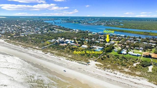 birds eye view of property featuring a water view and a view of the beach