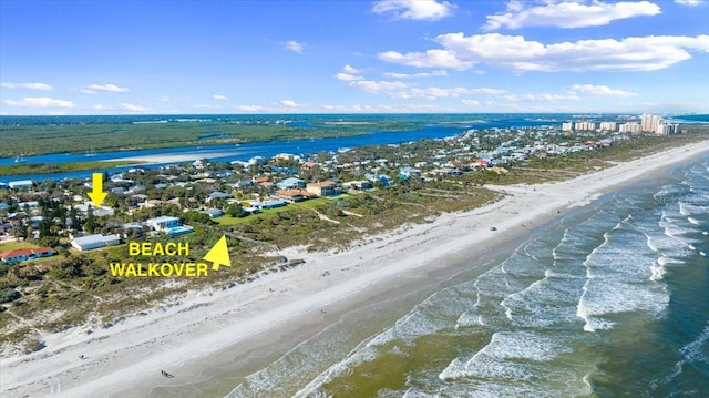 drone / aerial view with a water view and a view of the beach