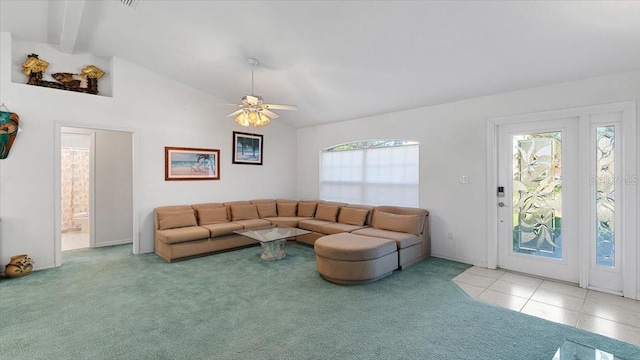 tiled living room featuring ceiling fan and lofted ceiling with beams