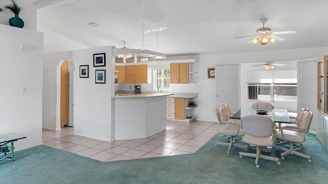 kitchen with light carpet, light brown cabinets, lofted ceiling, and ceiling fan with notable chandelier