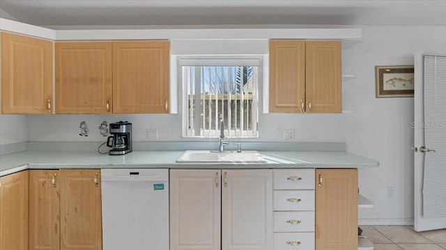 kitchen with light brown cabinets, sink, light tile floors, and dishwasher