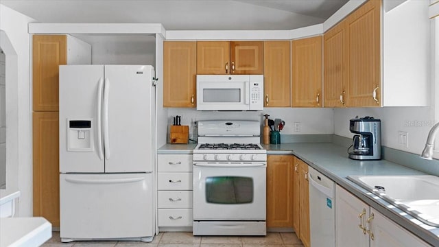 kitchen featuring light tile flooring, white appliances, and sink