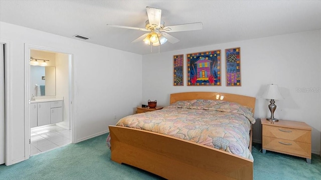 bedroom with carpet flooring, ensuite bath, ceiling fan, and sink