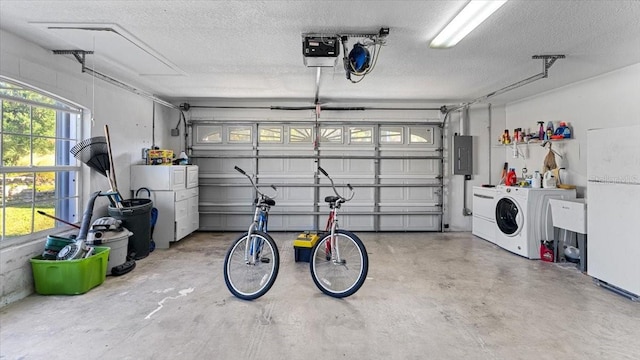 garage featuring a garage door opener, washer / dryer, and white refrigerator