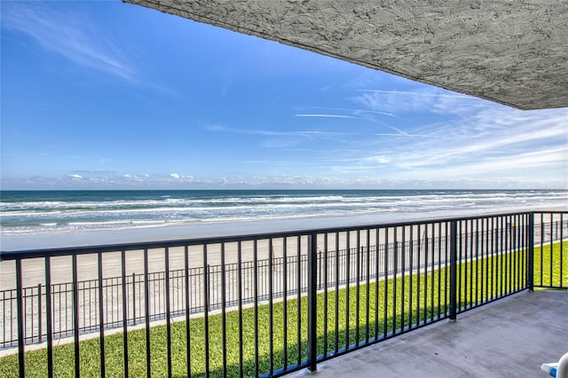 balcony with a water view and a beach view