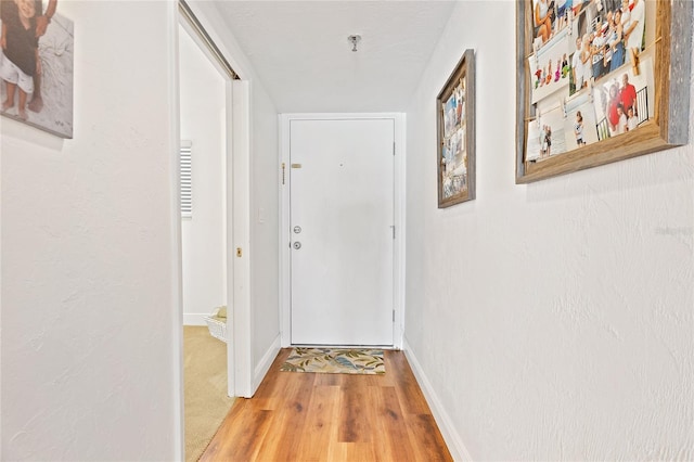 hall featuring light colored carpet