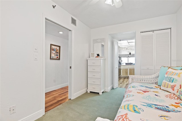 bedroom with a closet, ceiling fan, and carpet