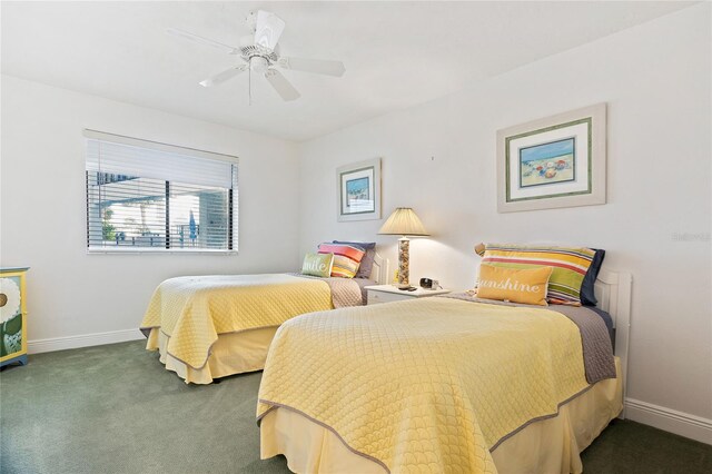 bedroom with ceiling fan and dark carpet
