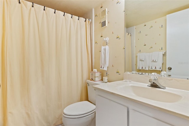 bathroom featuring oversized vanity and toilet