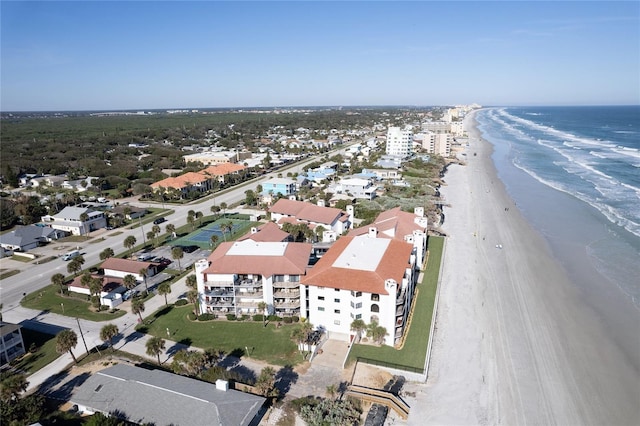 drone / aerial view featuring a beach view and a water view
