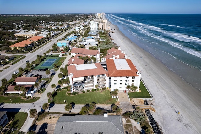 birds eye view of property with a beach view and a water view