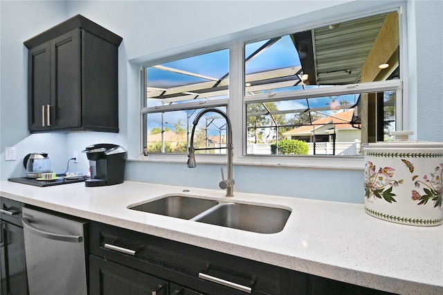 kitchen with light stone counters, sink, and dishwasher