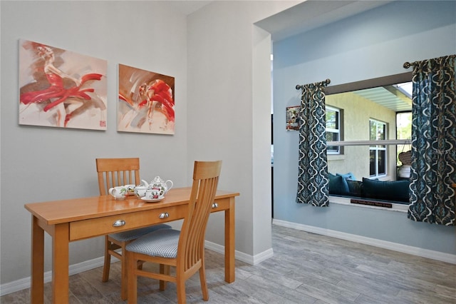 dining space with light wood-type flooring