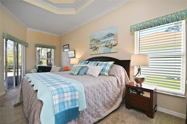 carpeted bedroom featuring a raised ceiling, ornamental molding, and access to outside