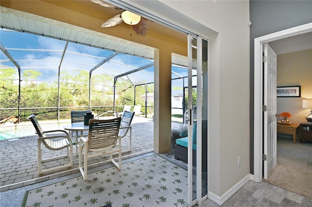 sunroom / solarium with a healthy amount of sunlight and ceiling fan