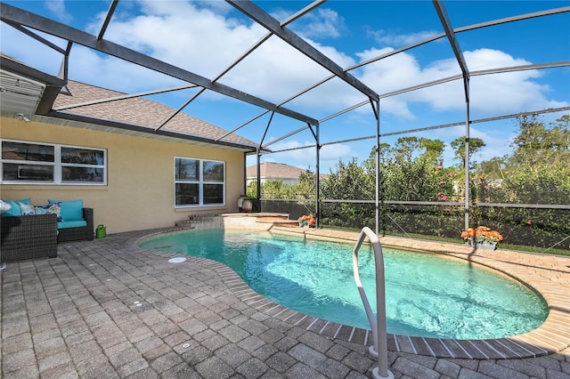 view of pool with a patio and a lanai