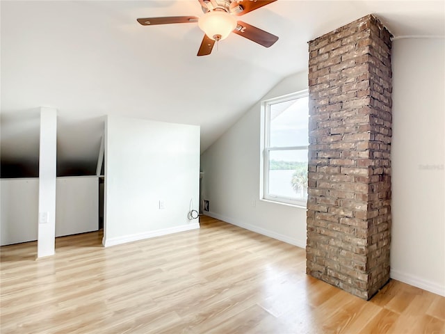 additional living space featuring ceiling fan, vaulted ceiling, and light wood-type flooring