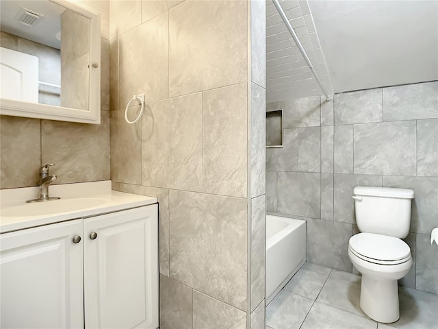 full bathroom featuring vanity, toilet, and tile walls