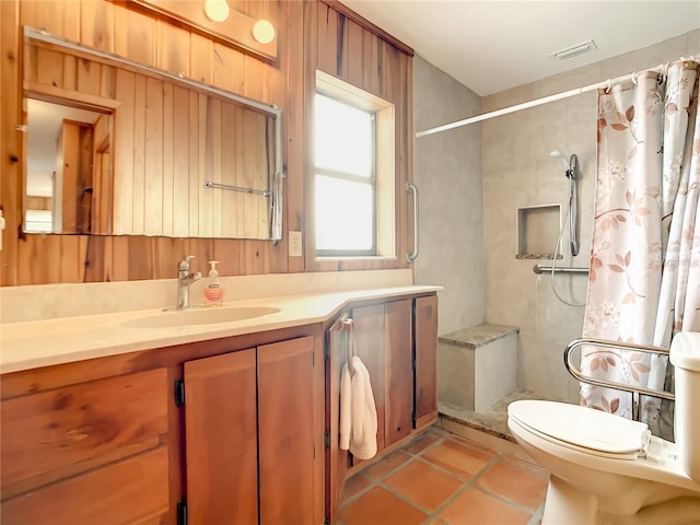 bathroom with a shower with curtain, toilet, vanity, and tile flooring