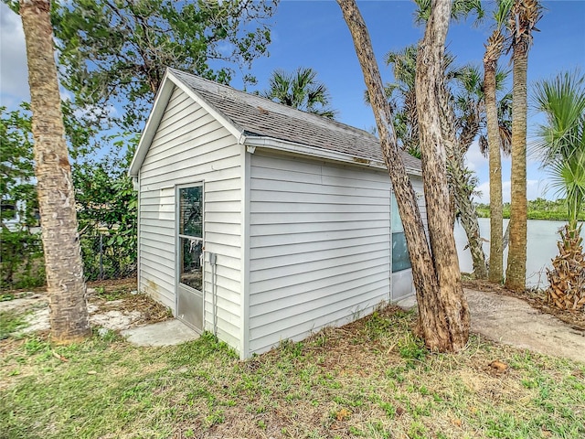 view of shed / structure with a water view