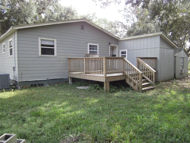 rear view of property featuring a lawn, central AC, and a wooden deck