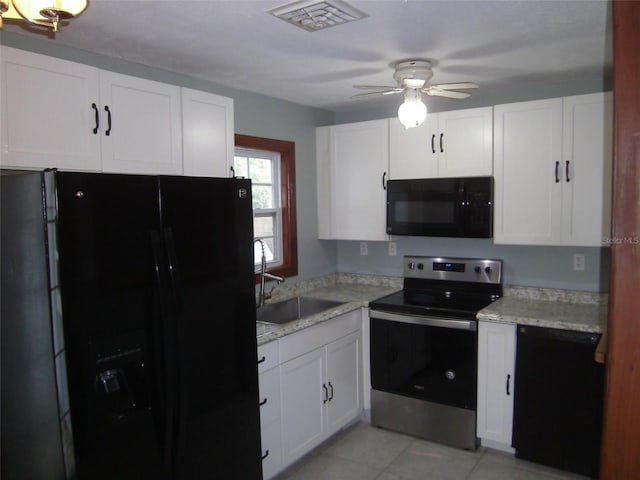 kitchen with sink, ceiling fan, light tile floors, black appliances, and white cabinetry