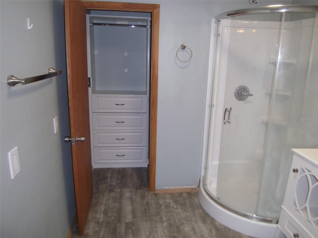 bathroom featuring hardwood / wood-style floors, an enclosed shower, and vanity