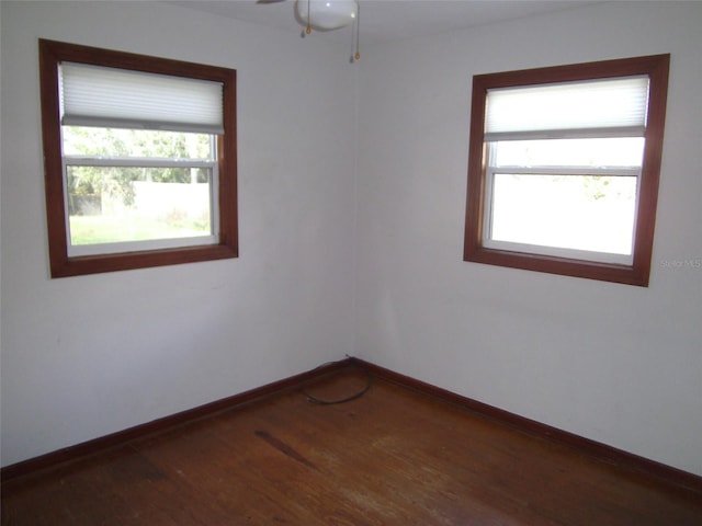 spare room with dark hardwood / wood-style floors