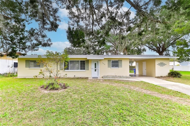 ranch-style home with a carport and a front lawn