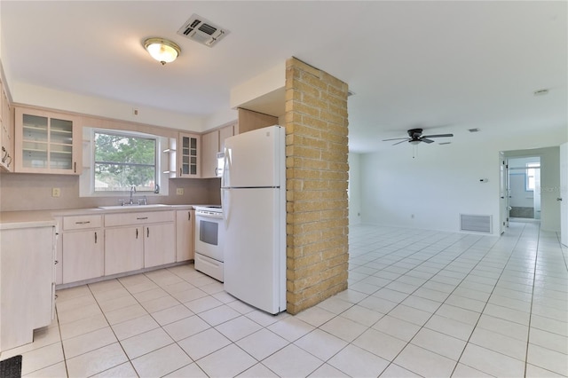 kitchen featuring ceiling fan, light tile flooring, white appliances, brick wall, and tasteful backsplash