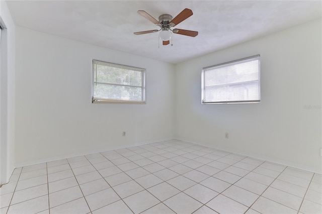 tiled empty room featuring ceiling fan