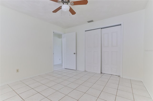 unfurnished bedroom featuring a closet, ceiling fan, and light tile floors