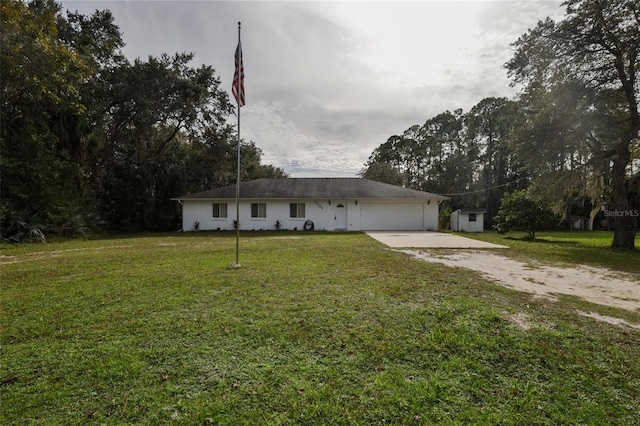 ranch-style home featuring a front lawn and a garage